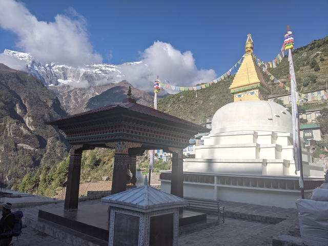 Stupa with mountains in the background.