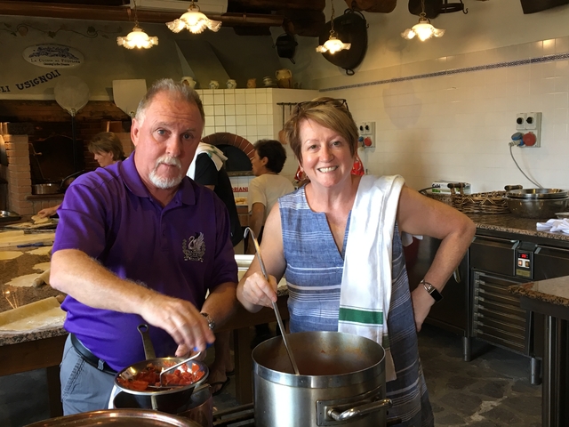       Two people cooking in a kitchen.
  