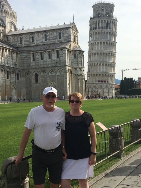      Couple in front of the Leaning Tower of Pisa.
  