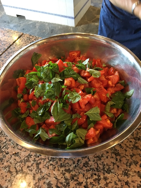       Bowl of chopped tomatoes and basil leaves.
  