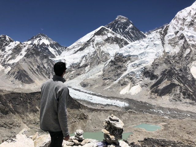 Person looking at snow-covered mountains.