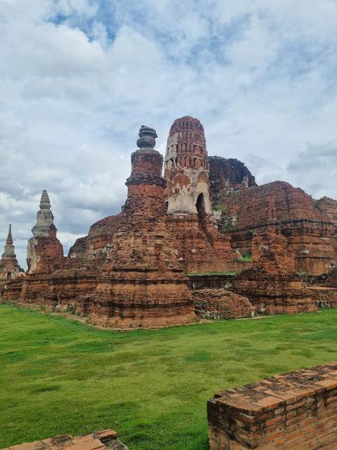 Ancient brick temple amidst greenery.