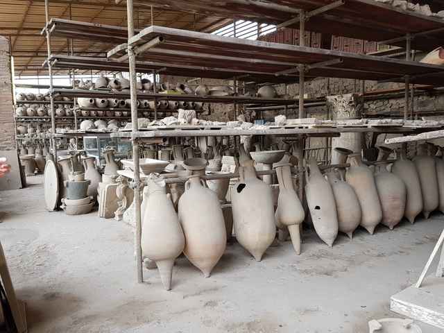       Storeroom filled with amphorae and other pottery artifacts.
  