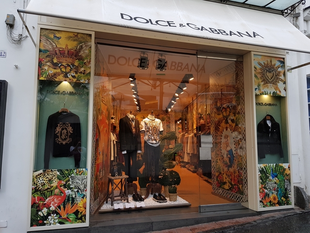       Luxury fashion store with mannequins and decorative walls.
  