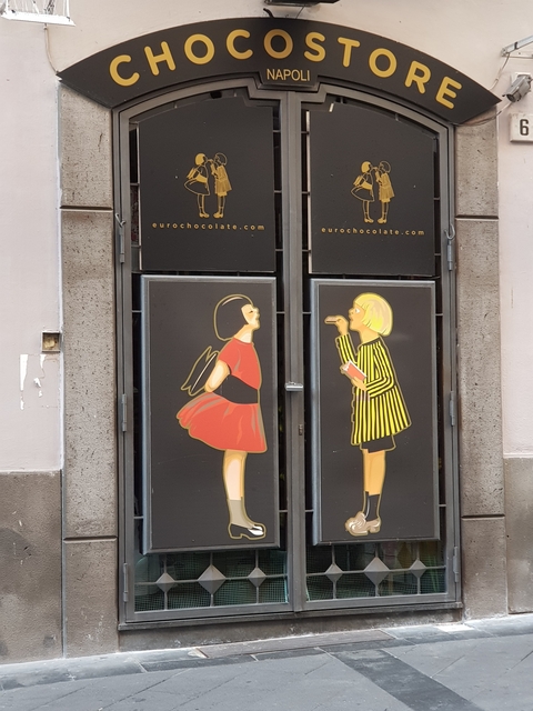       Artistic wall display of cartoon characters in an urban setting.
  