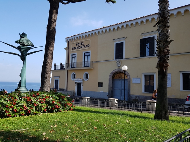       Exterior view of Hotel Tramontano against a backdrop of the sea.
  