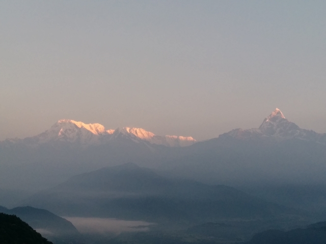 Himalayan mountains with snowy peaks at sunrise.