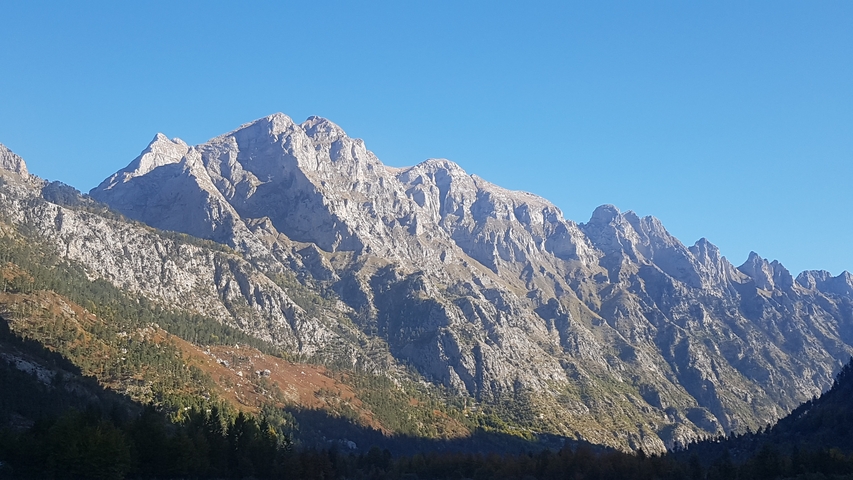 Rocky mountains under a clear blue sky.