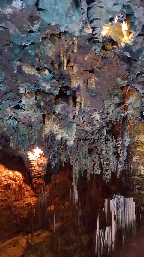 Rock formations with a torch in a cave.