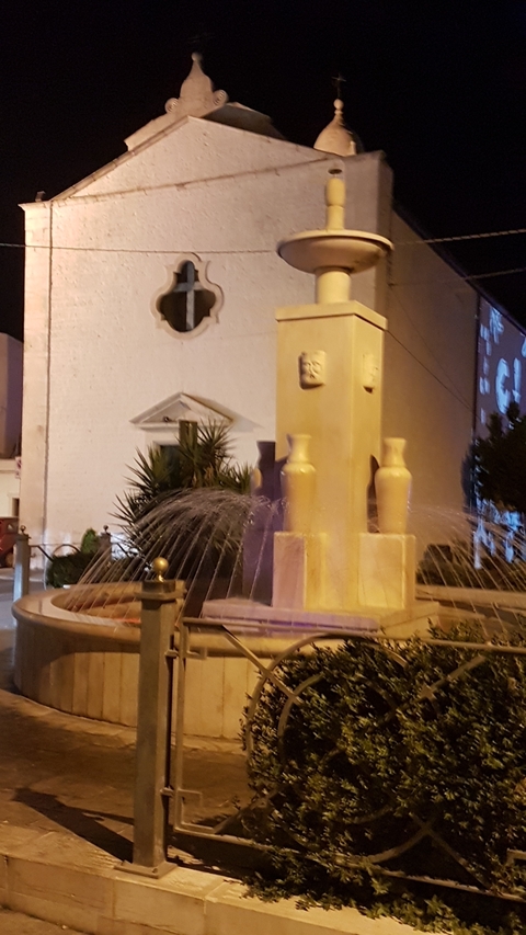       Blurred nighttime photo of a fountain.
  