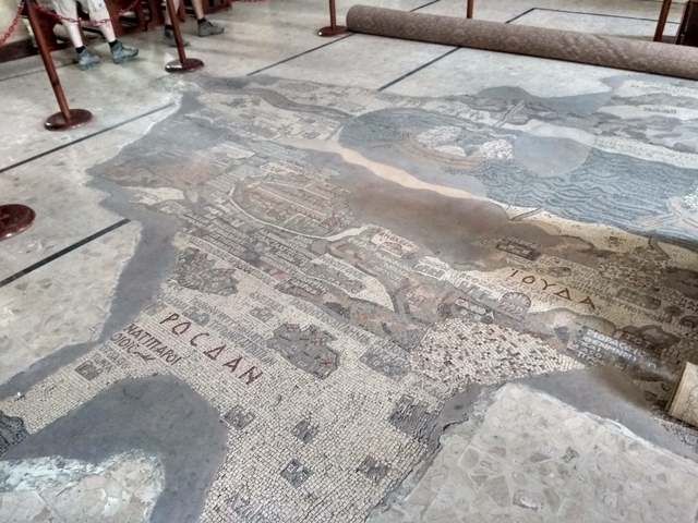       Mosaic map on a stone floor.
  