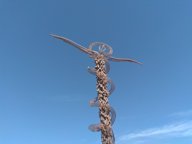       Sculpture against a clear blue sky.
  