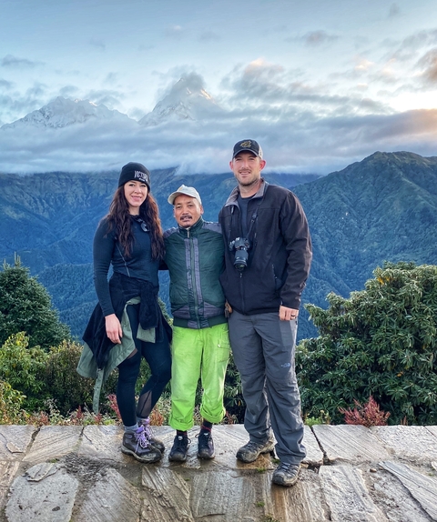 Tourists with a guide on a mountain peak.