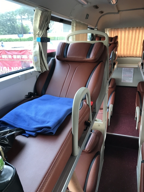 Interior of a modern bus with reclining seats.