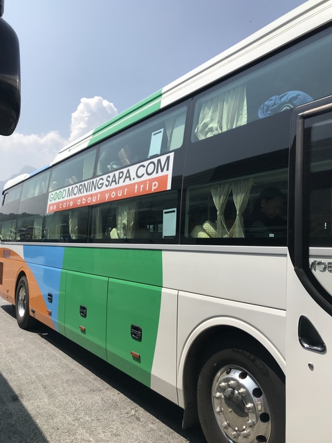 Exterior of a colorful tour bus with signage.