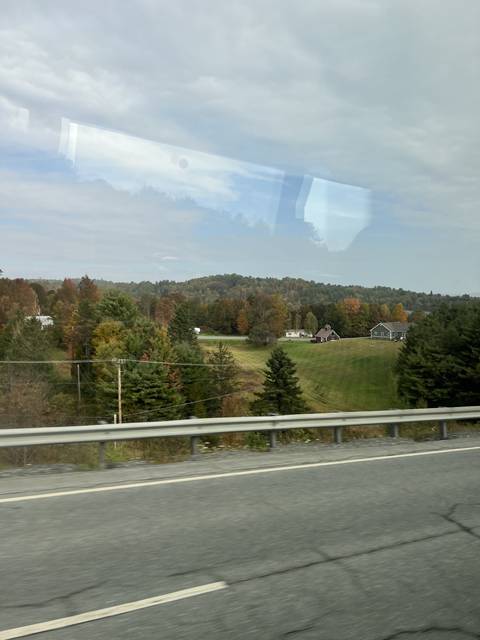       Rural scene with road, fields, and trees.
  