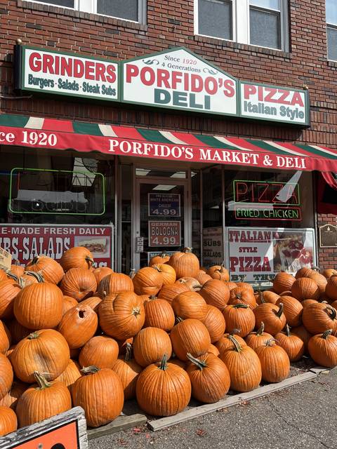 Storefront with pumpkins outside Porfido's Pizza and Deli.