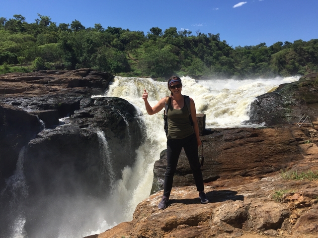       Person standing in front of Murchison Falls with a thumbs up.
  