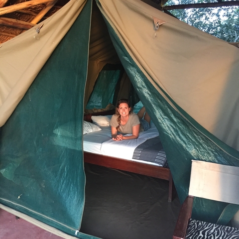       Person relaxing inside a tent.
  