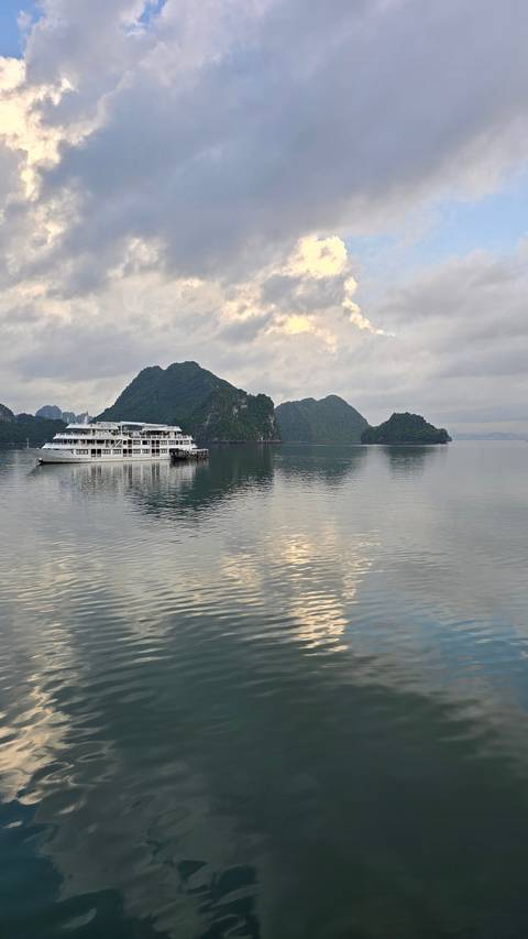       Calm sea with limestone islands in the distance
  