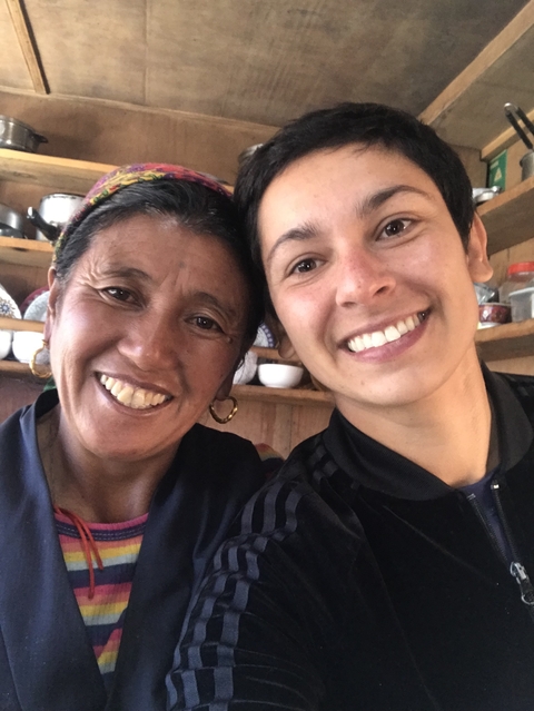 Two smiling women in a cozy setting.