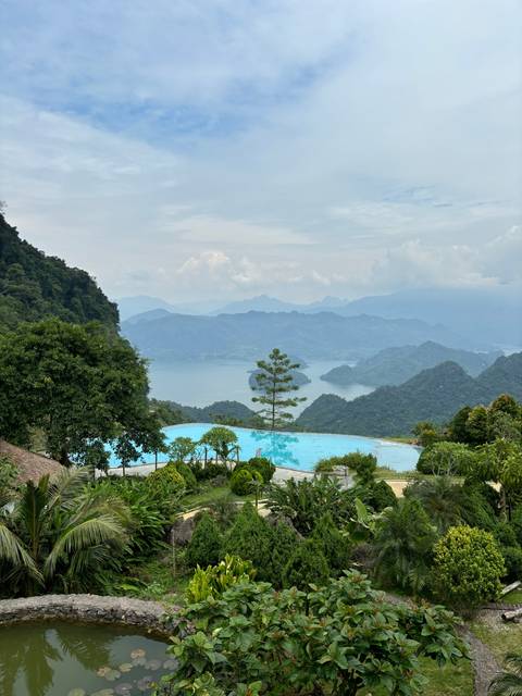 Landscape view with a pool and mountain ranges.