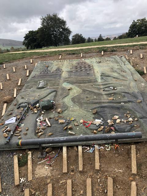 A monument with various items placed on it.