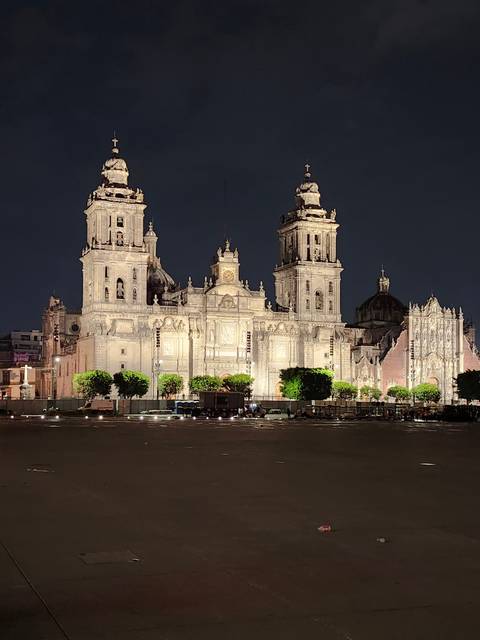       Illuminated cathedral with a dark sky background.
  