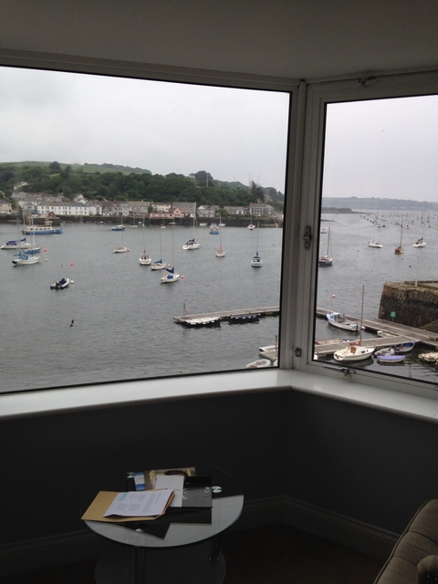       Window view of a harbor with sailing boats.
  