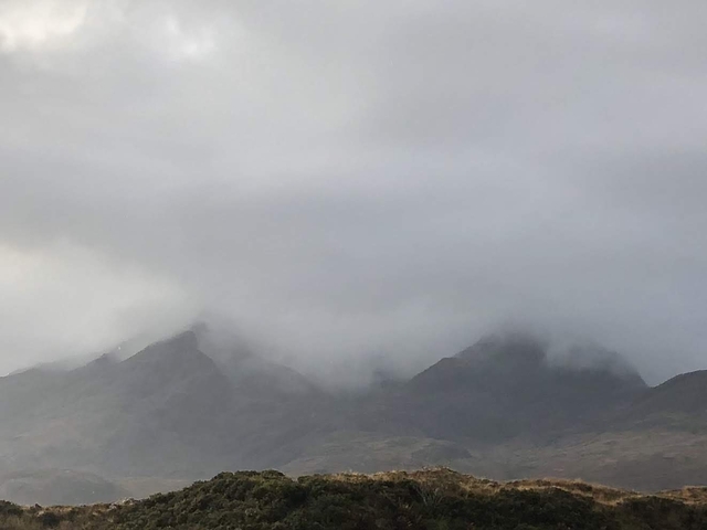       Mountain peak covered with clouds.
  
