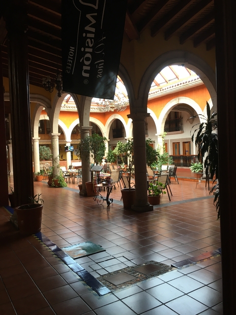       Beautiful courtyard with arches and plants.
  
