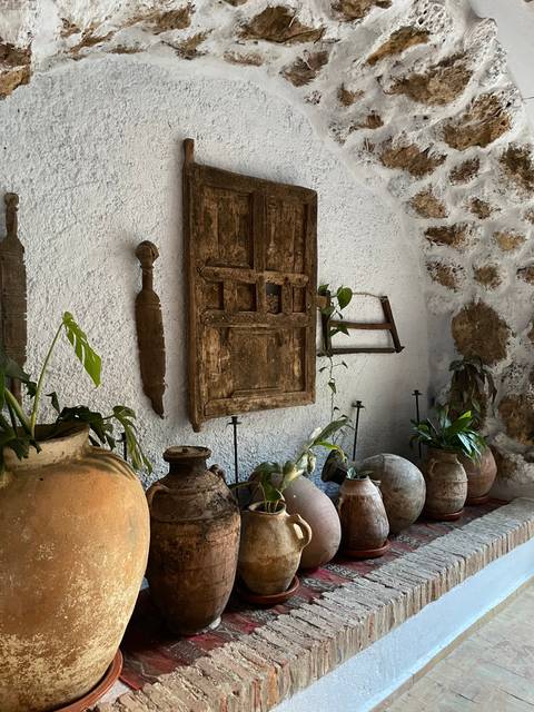 Display of traditional artifacts along a wall.