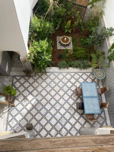 Courtyard garden with a tiled floor and plants.