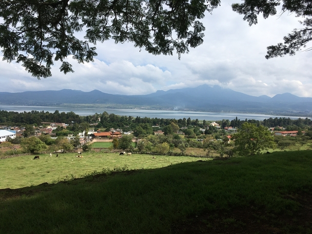       A scenic view of a rural landscape with mountains.
  