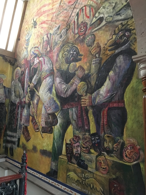       A mural depicting traditional dancers and musicians.
  