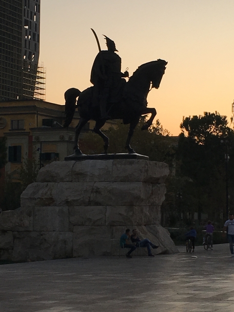 Silhouette of equestrian statue at sunset