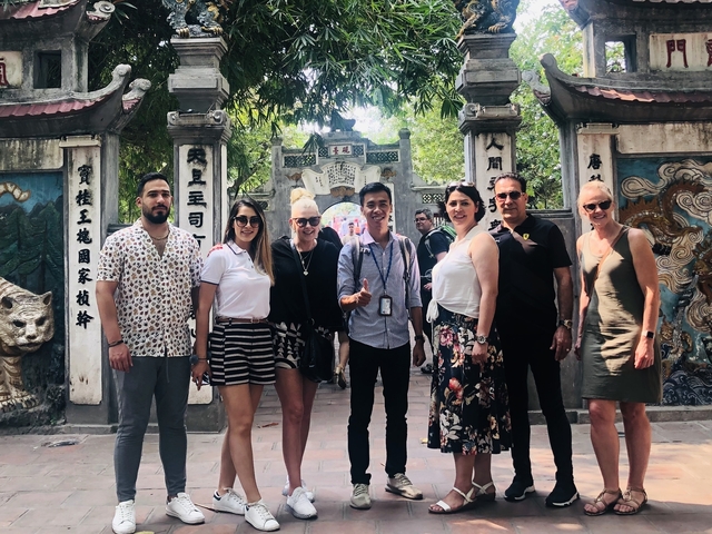 Group posing in front of a traditional archway.