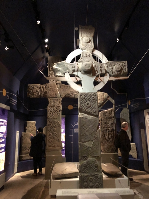       Inside museum with ancient stone cross artifacts.
  