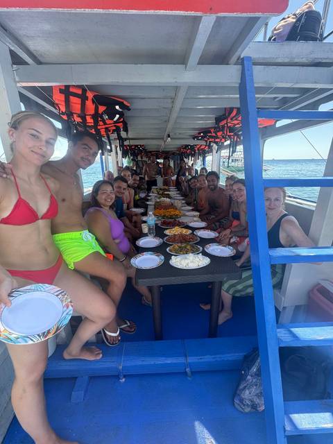 Group of people having a meal on a boat.
