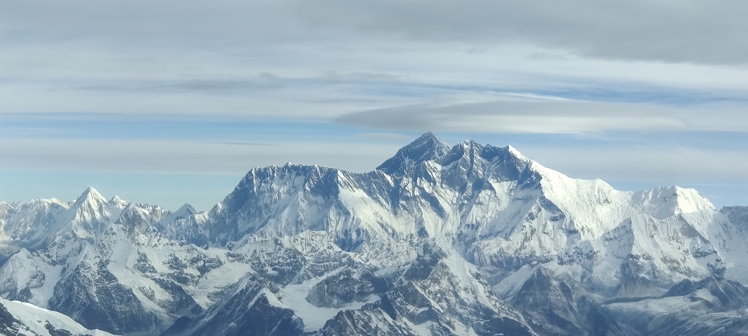       Aerial view of snowy Himalayan mountains.
  