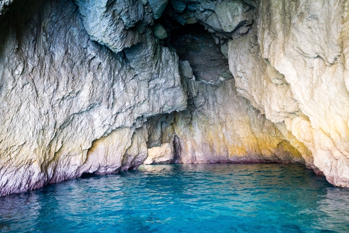 Water-filled cave with rock formations.