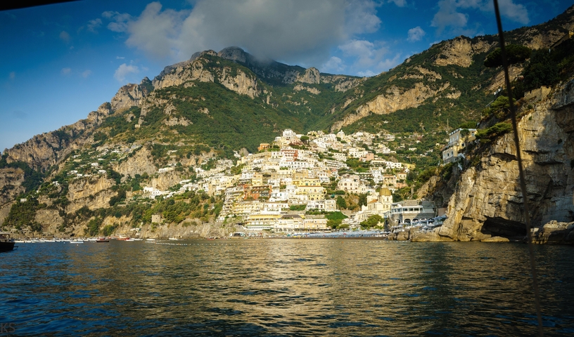 Hillside town with colorful buildings near the sea.