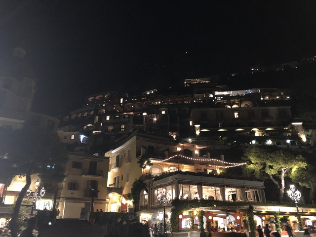 Hillside houses illuminated at night.
