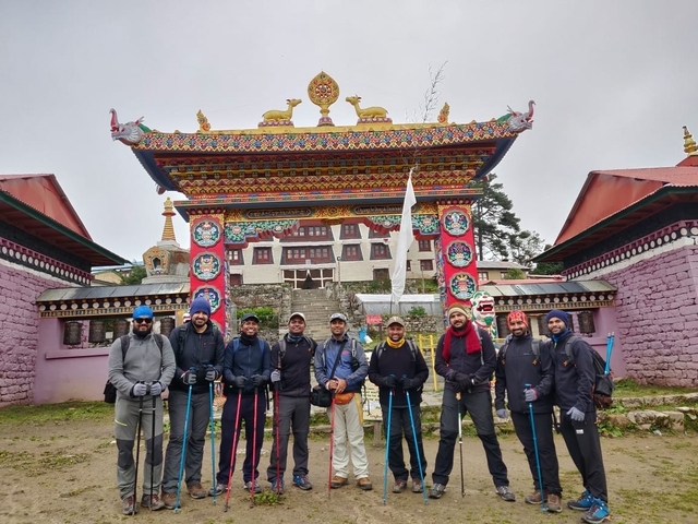 Group of hikers posing in front of a traditional gate.