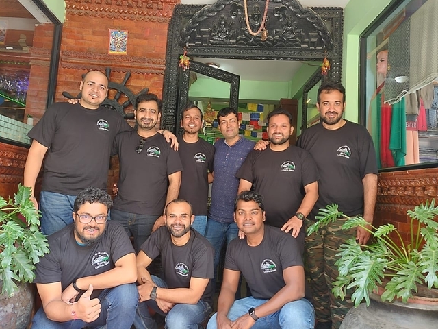 Group of people in a restaurant with colorful decor.