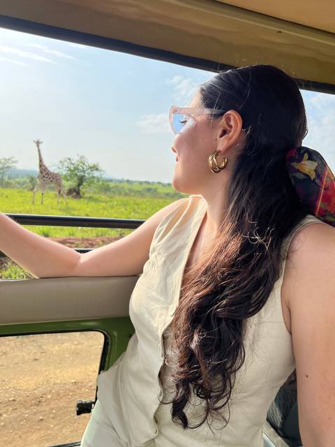 Woman looking out from a vehicle window on safari.