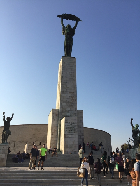 Stone monument with text and sculptures.