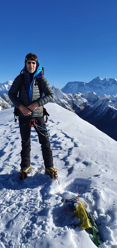       A person in climbing gear on a snowy mountain.
  