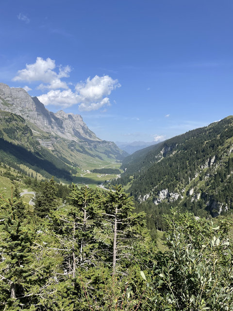 Scenic view of a valley with mountains and a clear sky.