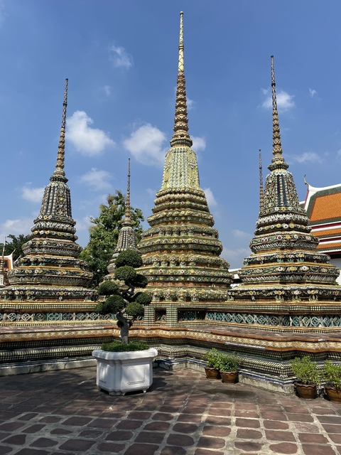       Colorful temple spires adorned with mosaic tiles.
  